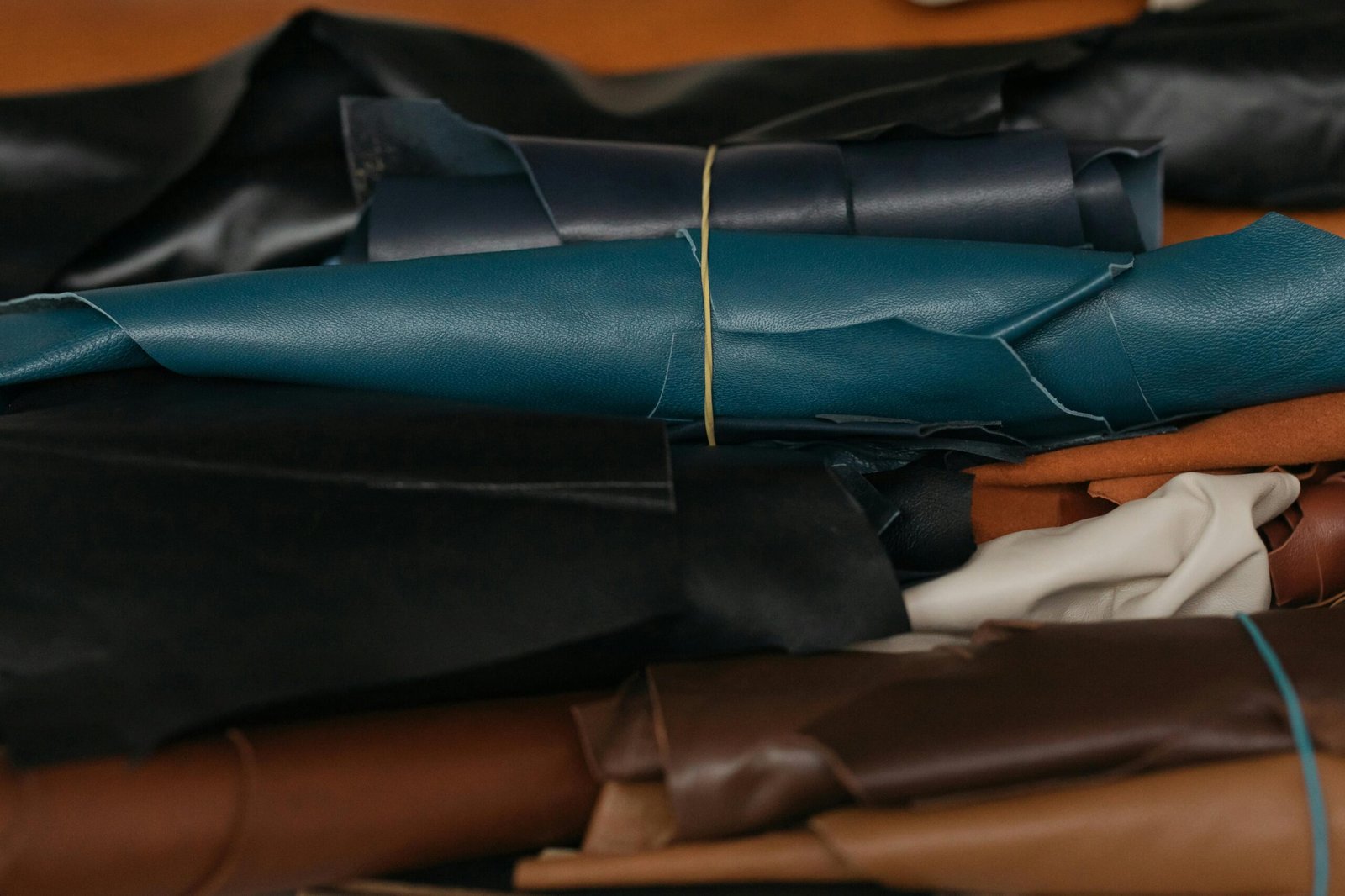 Close-up view of colorful leather rolls, perfect for crafting and textile production.